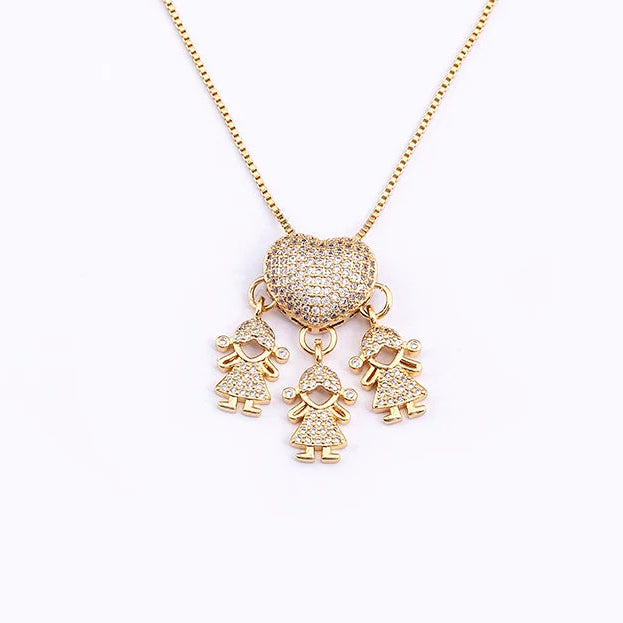 Gold necklace with three charms on a white background