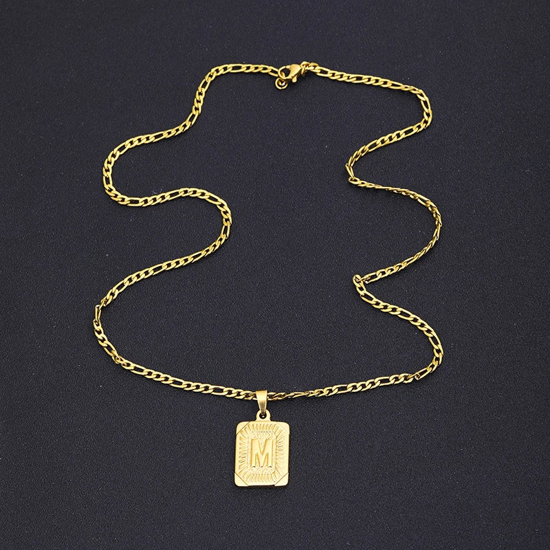 Gold necklace with a pendant on a dark background