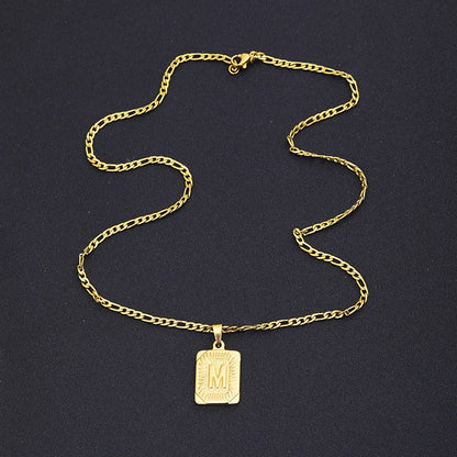 Gold necklace with a pendant on a dark background