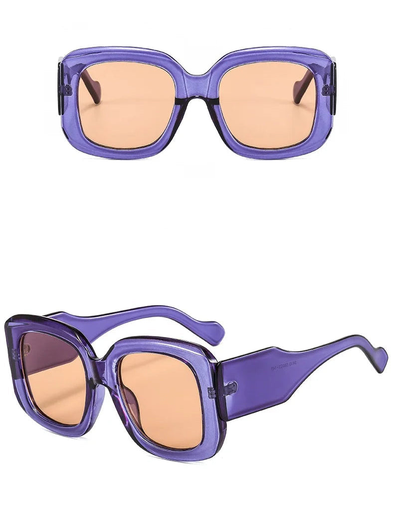 Purple sunglasses with orange lenses on a white background