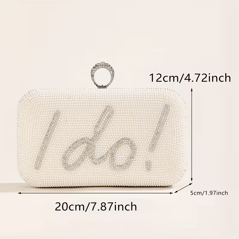 White beaded clutch bag with 'I do!' text and measurements on a beige background