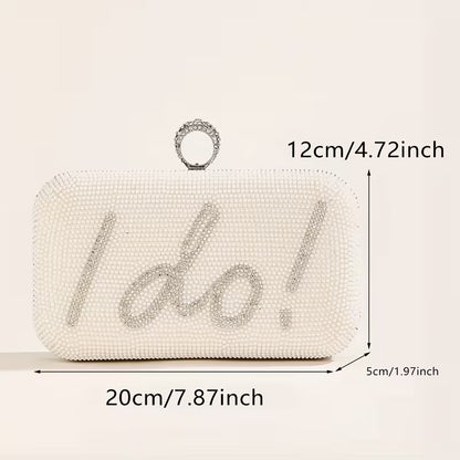 White beaded clutch bag with 'I do!' text and measurements on a beige background