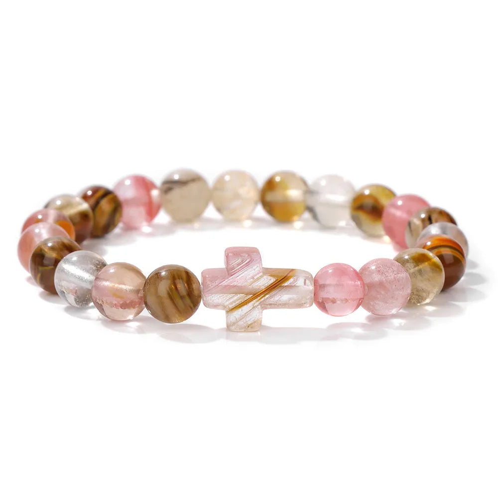 Multicoloured beaded bracelet with a cross charm on a white background