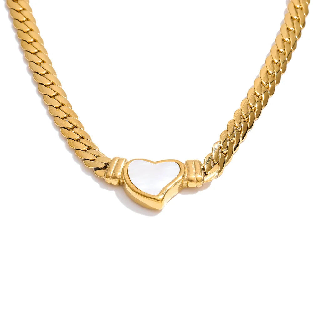 Gold chain necklace with a heart-shaped white pendant on a white background