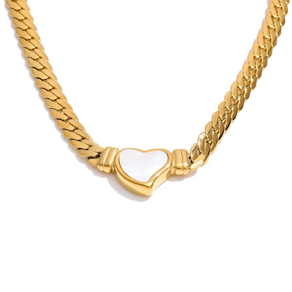 Gold chain necklace with a heart-shaped white pendant on a white background