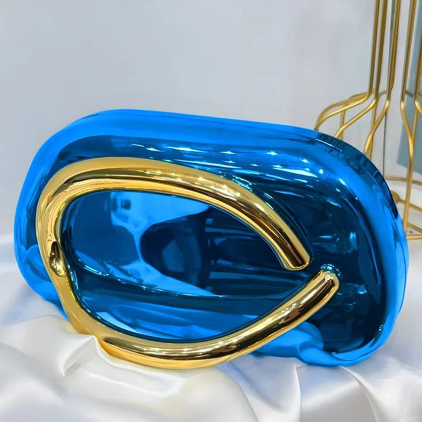 Blue and gold handbag on a white fabric background