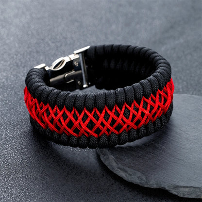 Black and red braided bracelet on a dark surface