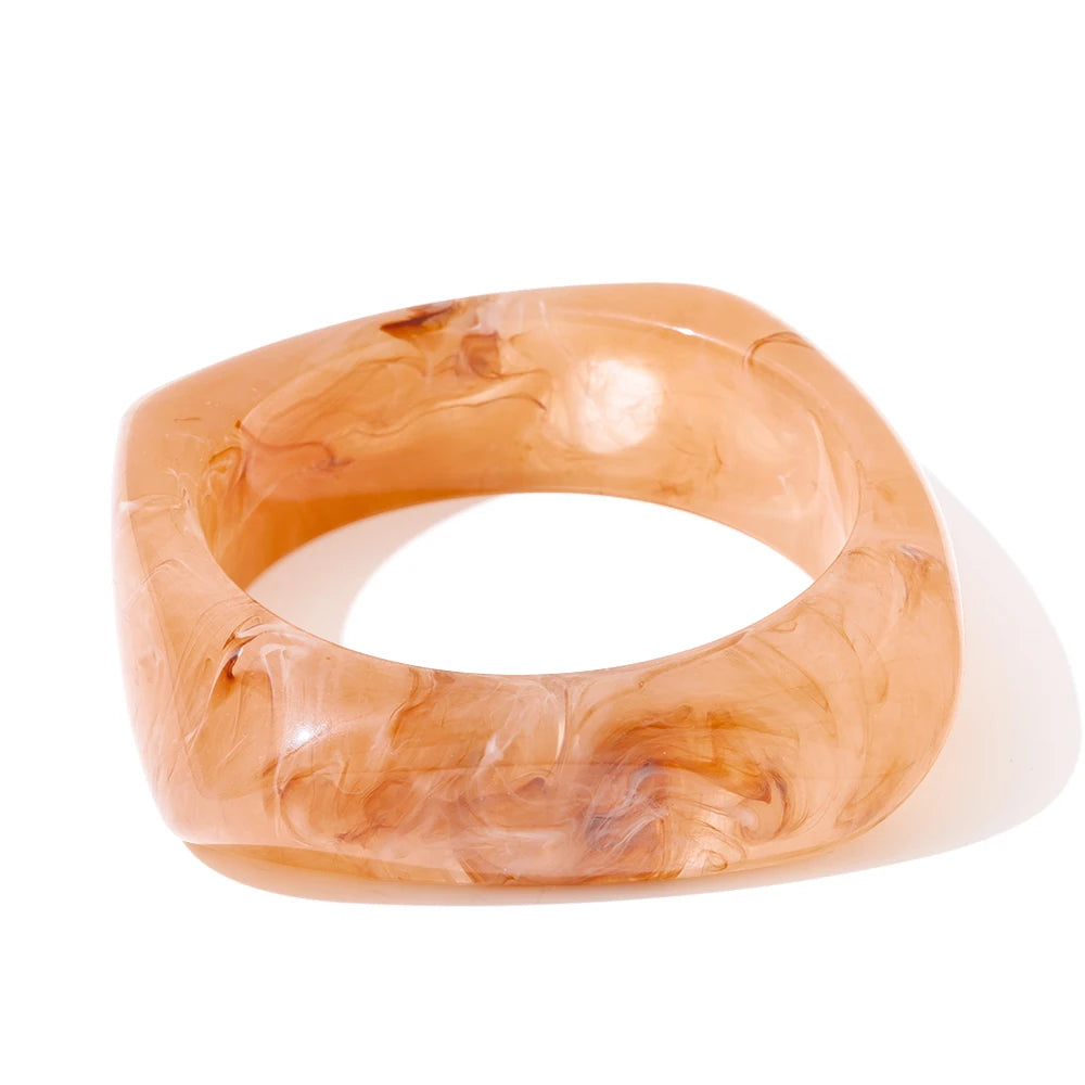 Orange marbled bangle on a white background