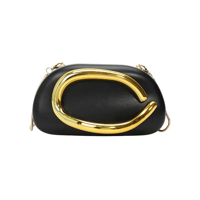 Black clutch with gold buckle frame handle on a white background