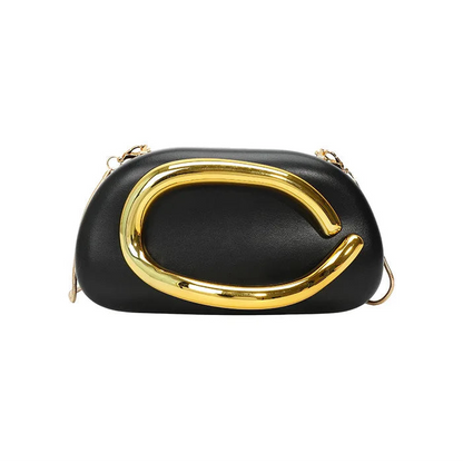Black clutch with gold buckle frame handle on a white background