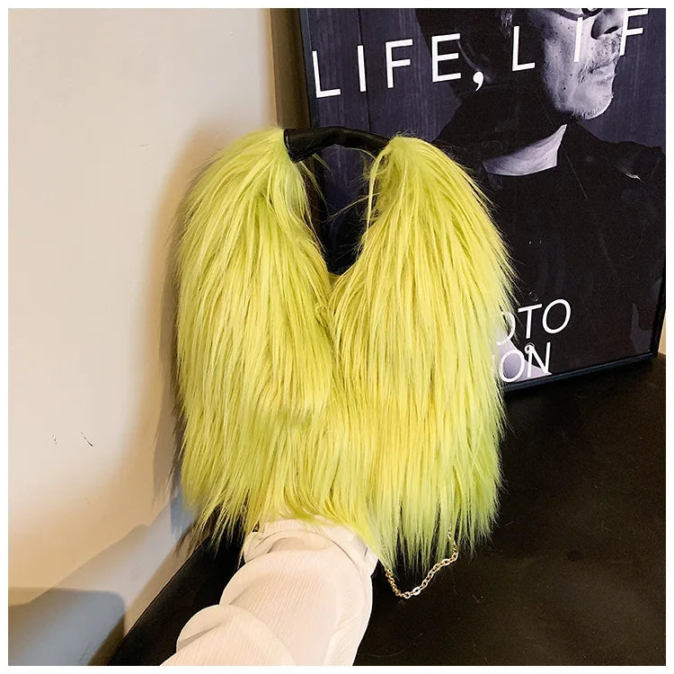 Neon green fur bag held by a person with a magazine in the background