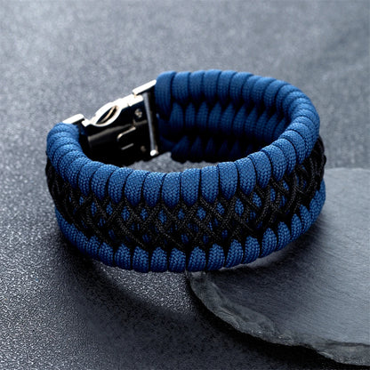 Blue and black braided bracelet on a dark surface