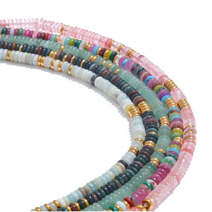 Set of colourful beaded necklaces on a white background
