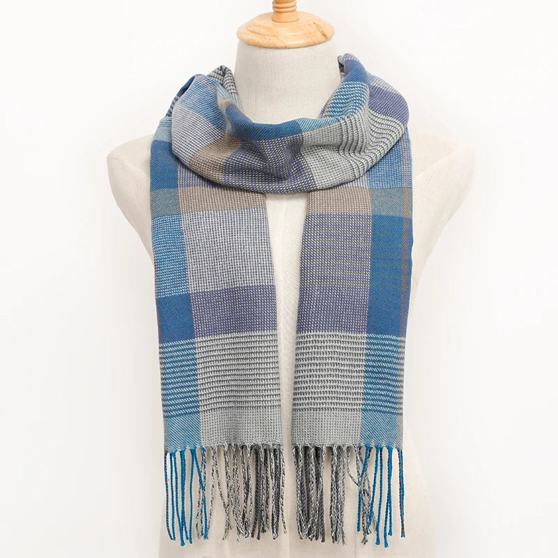 Blue and grey plaid scarf with fringe on a mannequin against a white background