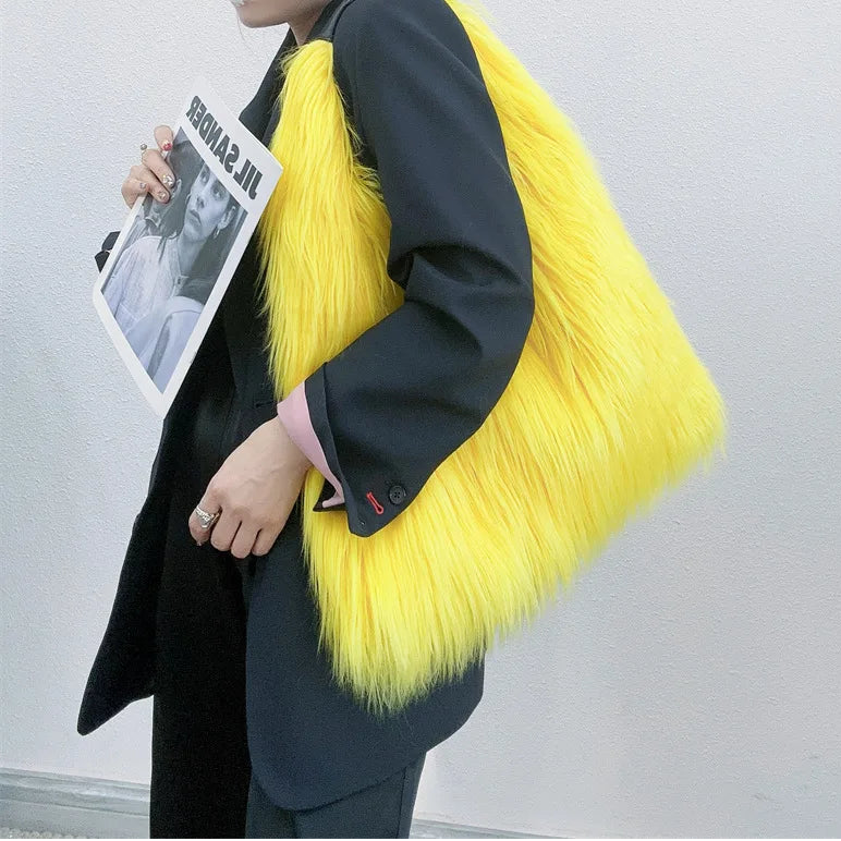 Person wearing a bright yellow fur coat holding a magazine against a plain background