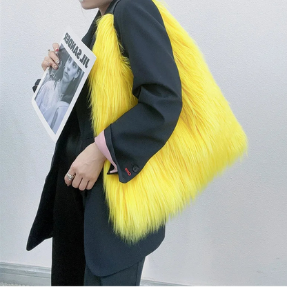 Person wearing a bright yellow fur coat holding a magazine against a plain background