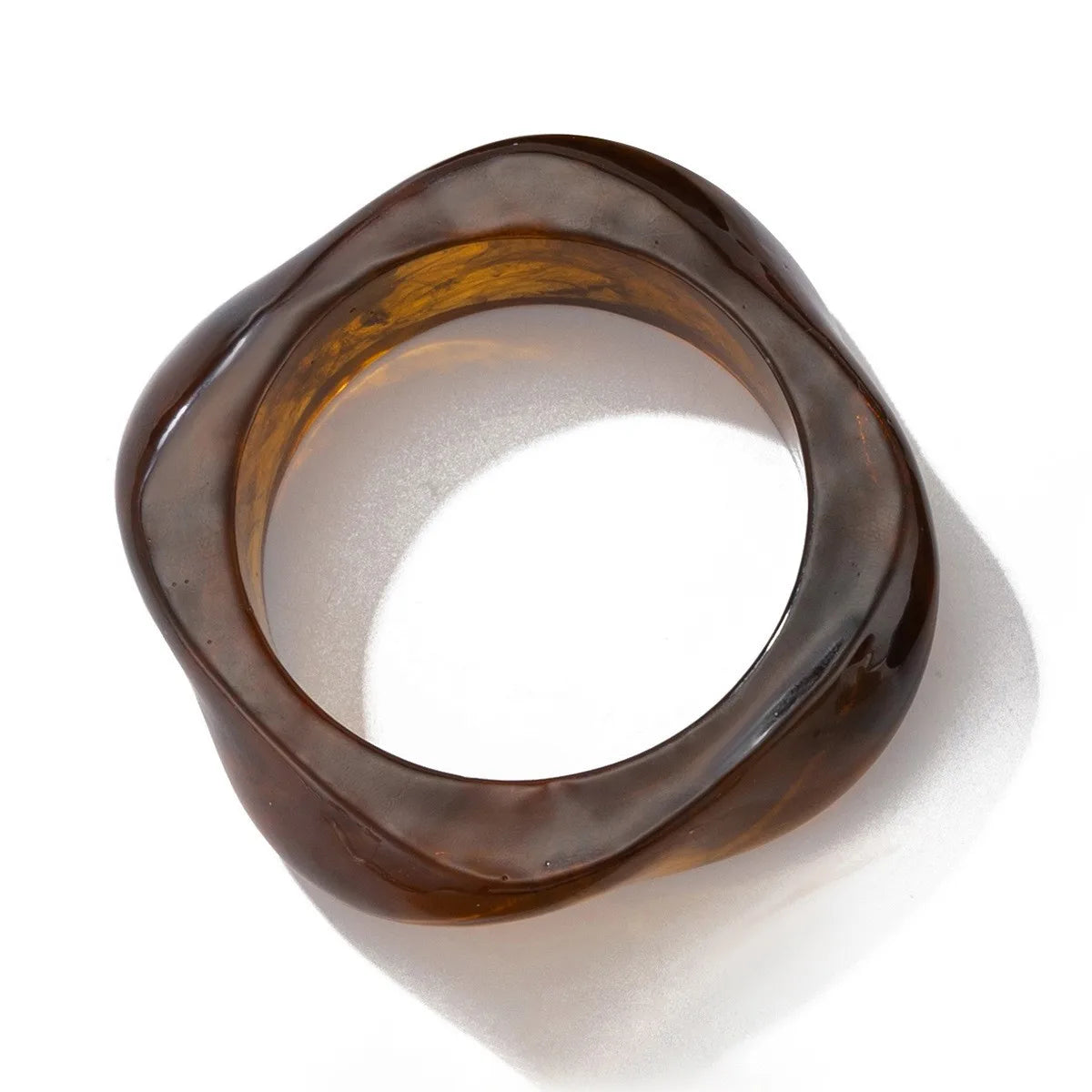 Brown glass bangle on a white background
