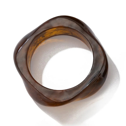 Brown glass bangle on a white background