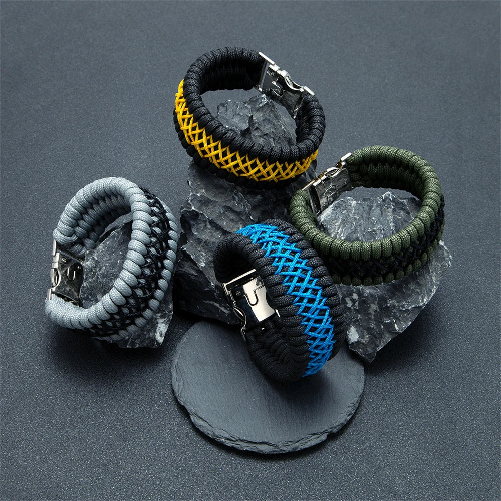 Five braided paracord bracelets  in different colours on a dark surface.