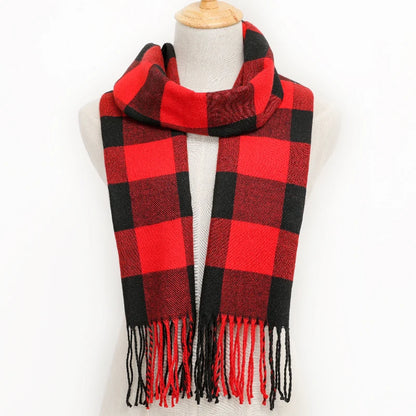 Red and black plaid scarf with fringes on a mannequin against a white background