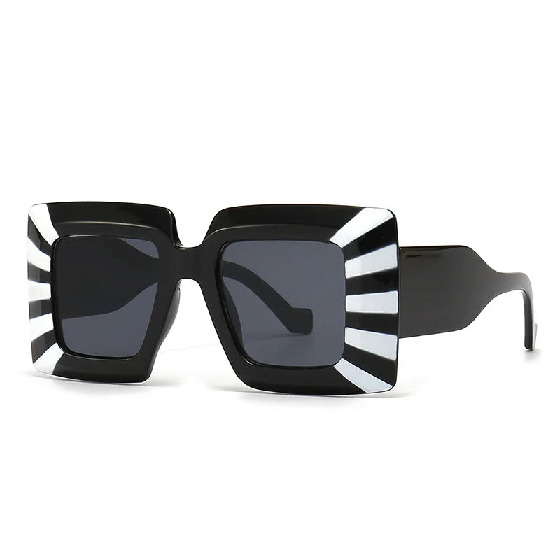 Sunglasses with black frame and striped sides on a white background
