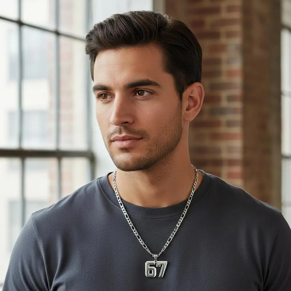 Man wearing a necklace with a '67' pendant in an indoor setting