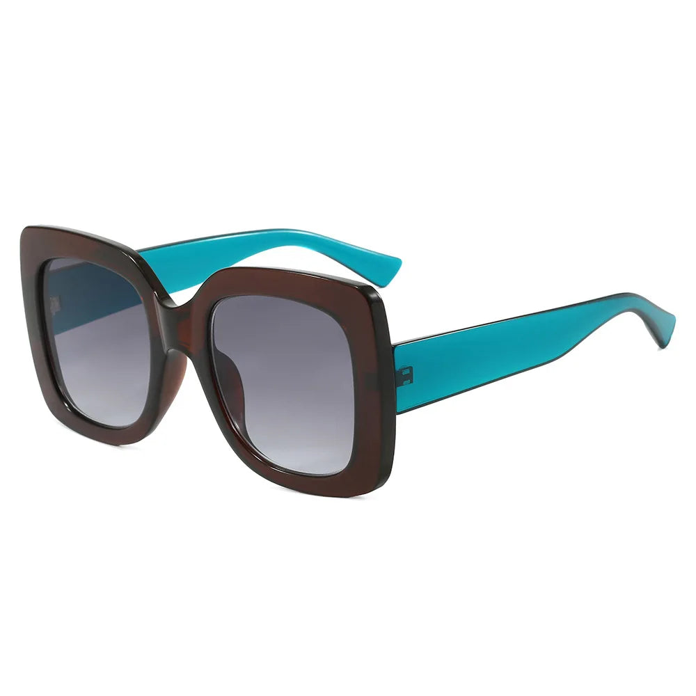 Oversized square sunglasses with a dark brown translucent frame, gradient grey lenses, and bright turquoise acetate temples, shown on a plain white background.