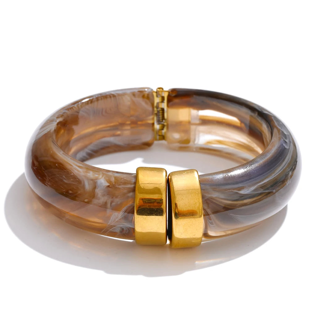 Multicoloured bracelet with gold clasp on a white background