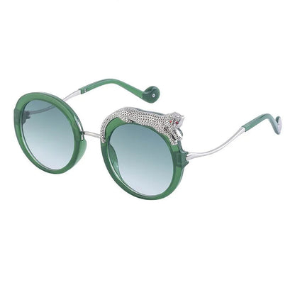 Green sunglasses with decorative arm on a white background.