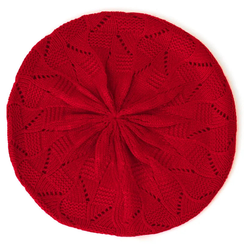 Red knitted beret on a white background