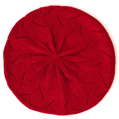 Red knitted beret on a white background