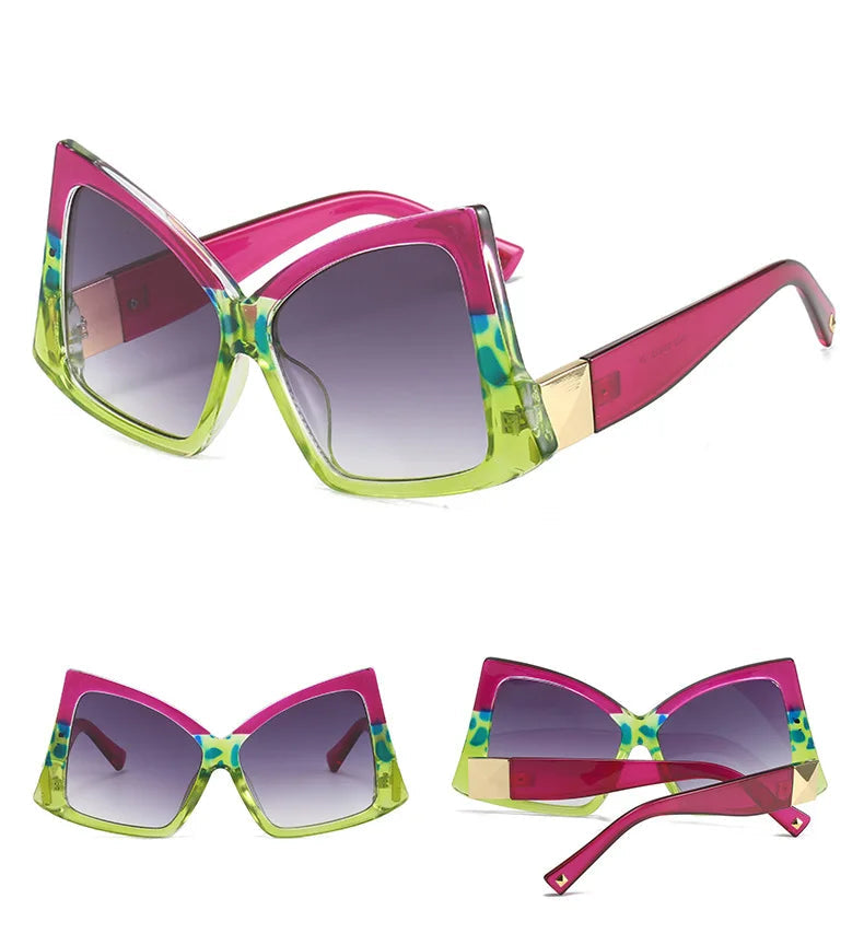 Three views of a pair of oversized cat-eye sunglasses with a bright pink and lime green frame, patterned green and blue detailing, and gold metal accents on the temples.