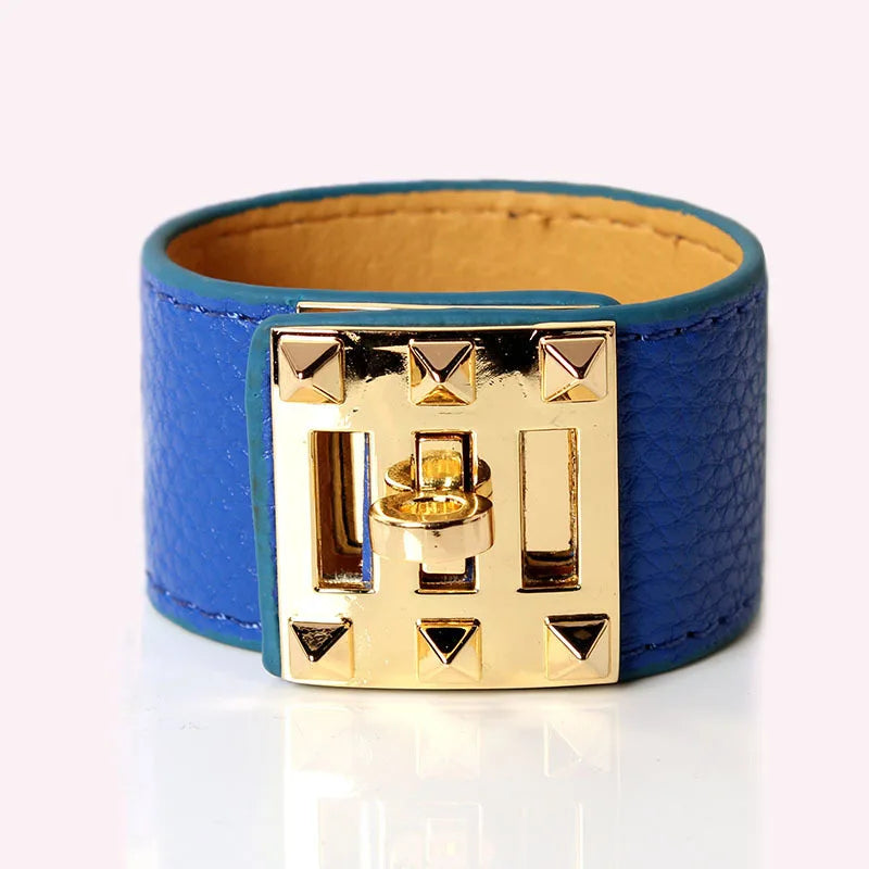 Blue leather bracelet with gold clasp on a white background