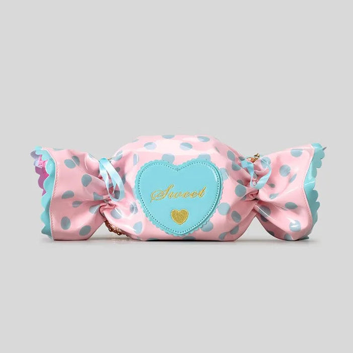 Product display of a pink candy shaped bag with a heart label on a grey background