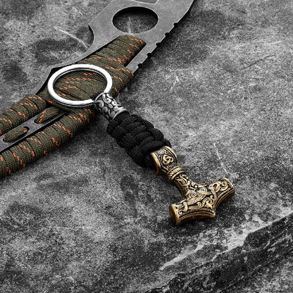 Keychain with Thor's hammer design on a textured surface
