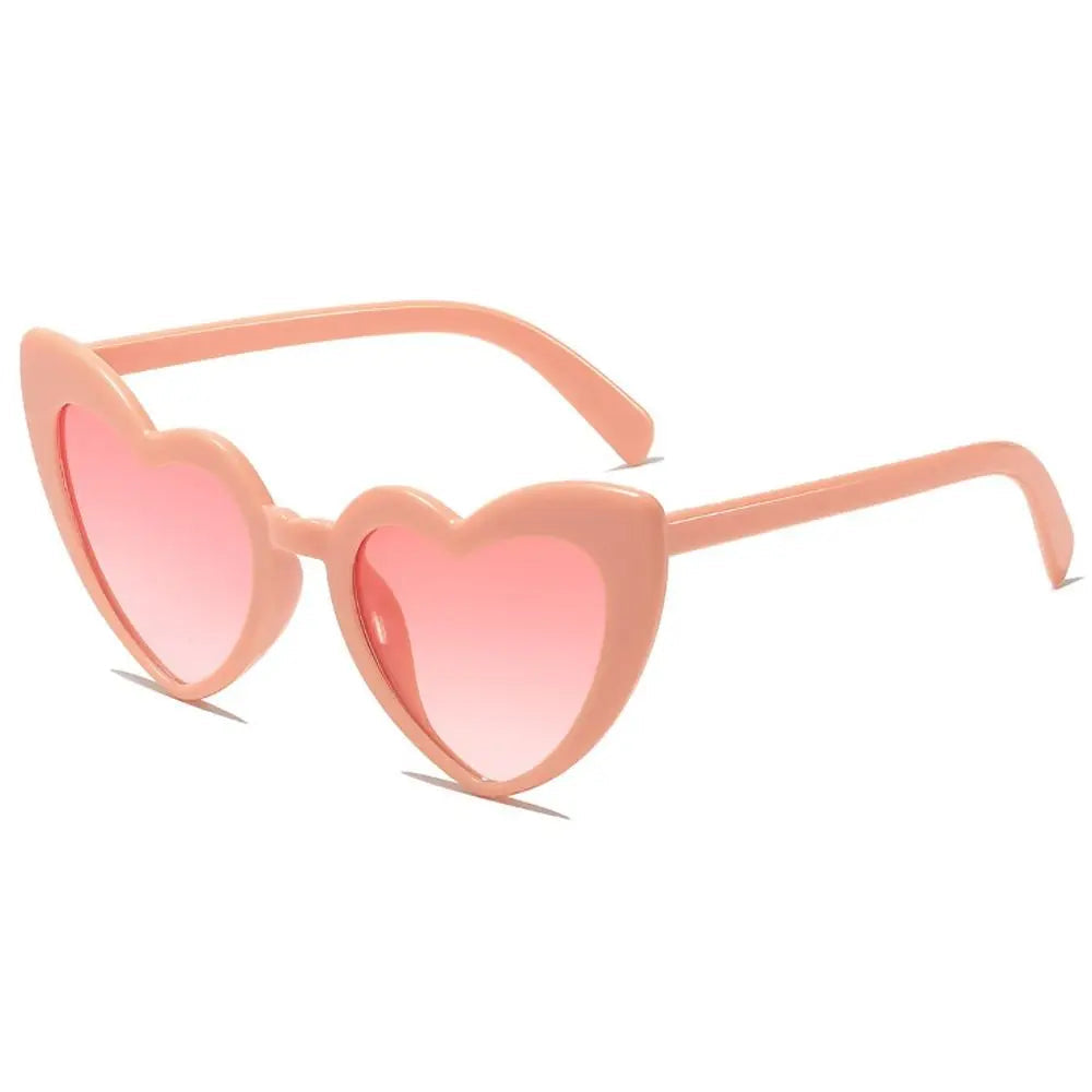 Heart-shaped pink sunglasses on a white background