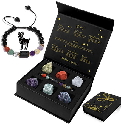 Set of crystals and a bracelet with zodiac sign design, displayed in an open black box.