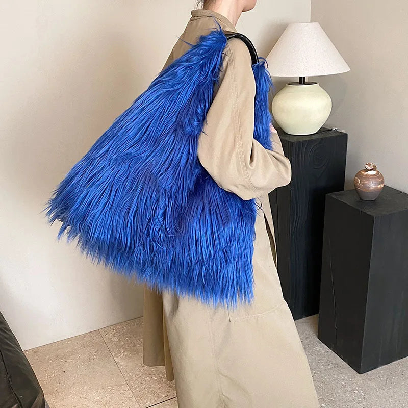 Person wearing a blue fluffy bag in an indoor setting with a lamp and decorative items.