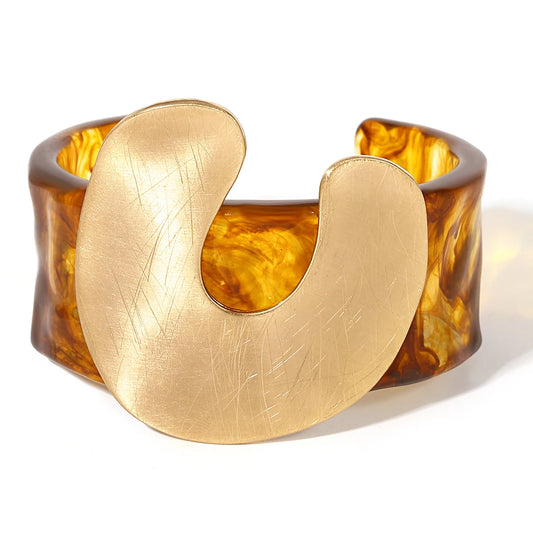 Gold and amber-coloured bracelet on a white background