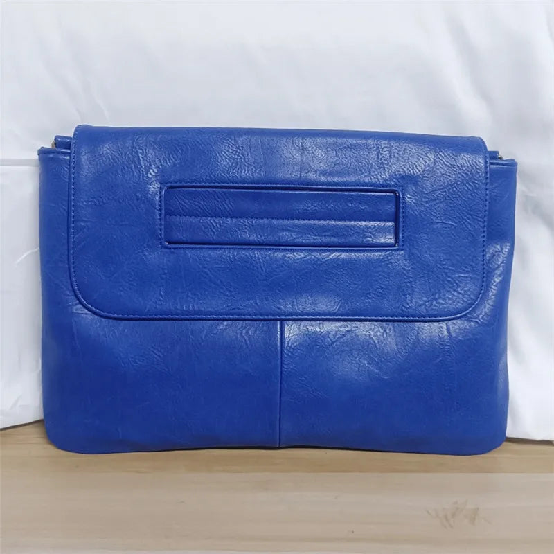 Blue leather clutch bag on a white background