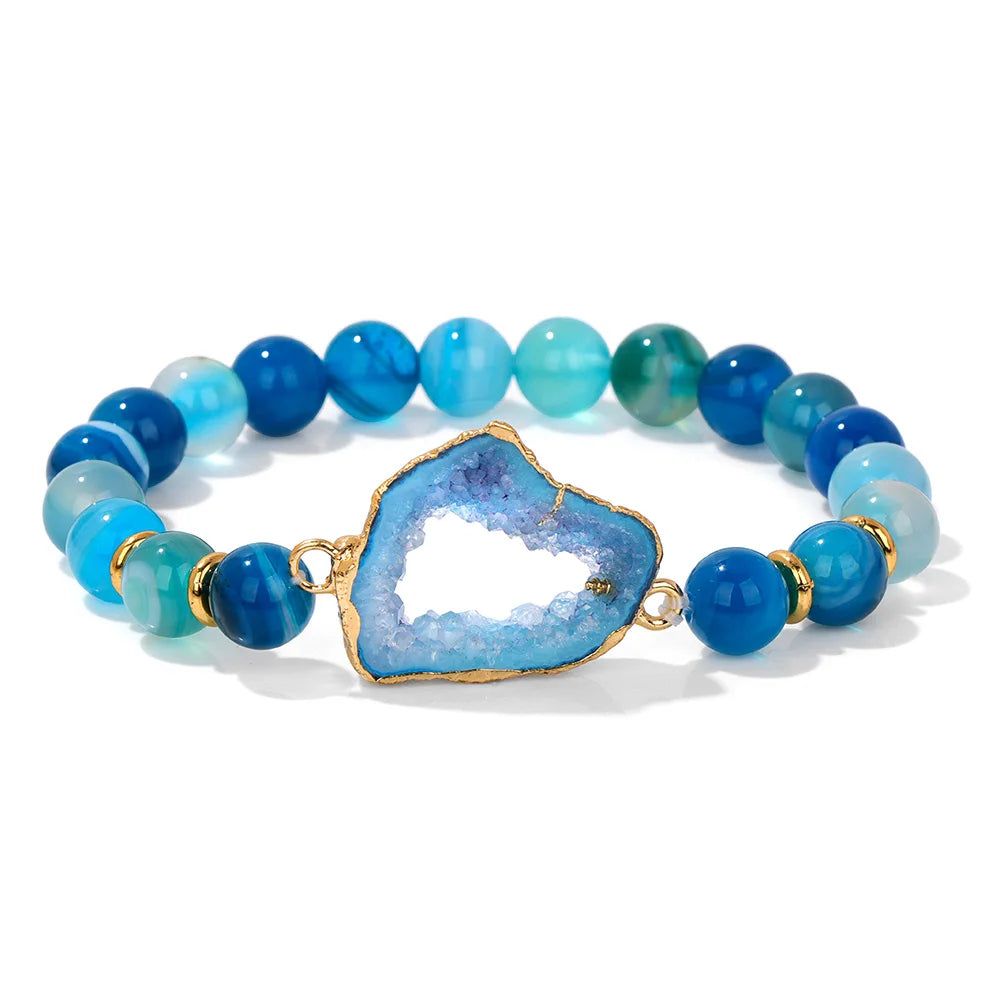 Blue beaded bracelet with a central blue stone on a white background