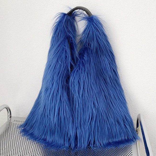 Blue shaggy handbag on a metal trolley against a white wall