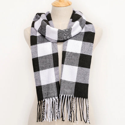 Black and white checkered scarf with fringes on a mannequin against a white background