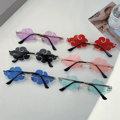 Set of colorful cloud-shaped sunglasses on a white surface