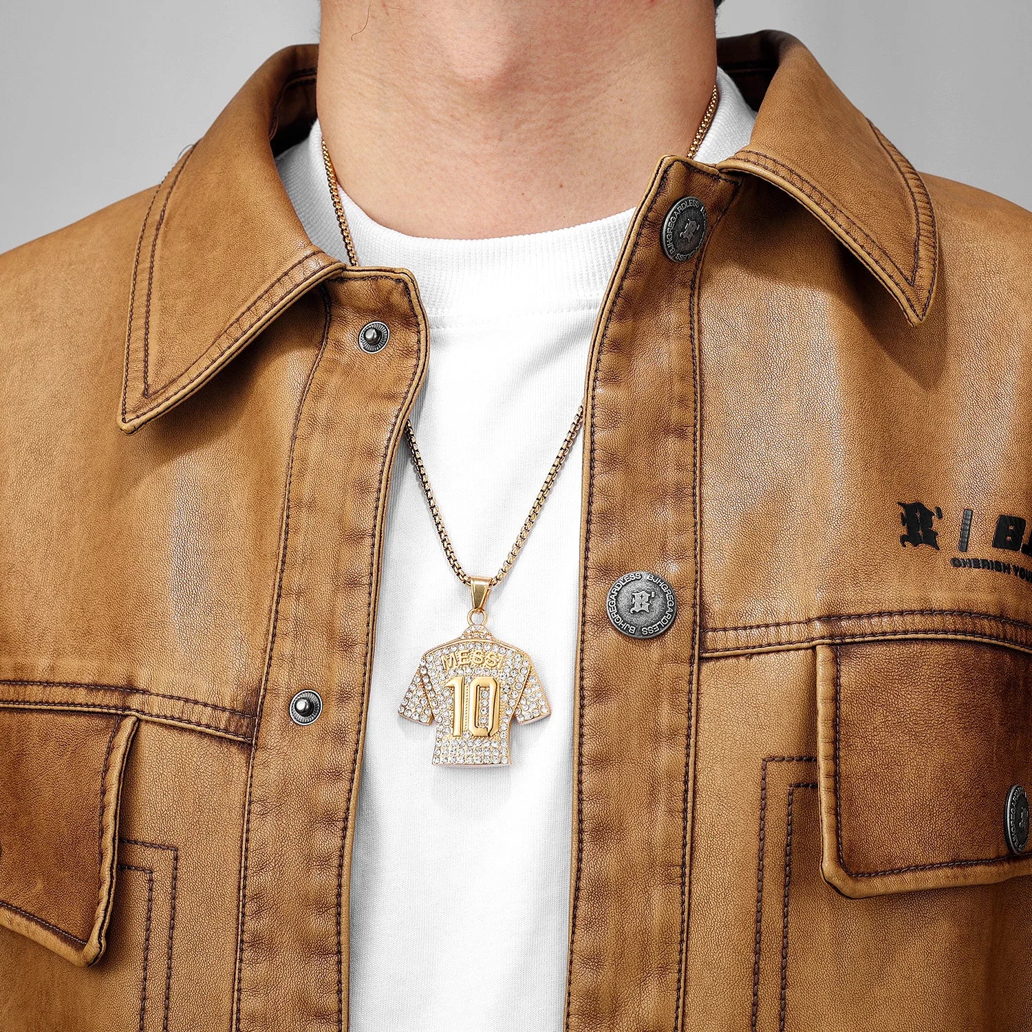 Brown jacket with a gold necklace worn by a person