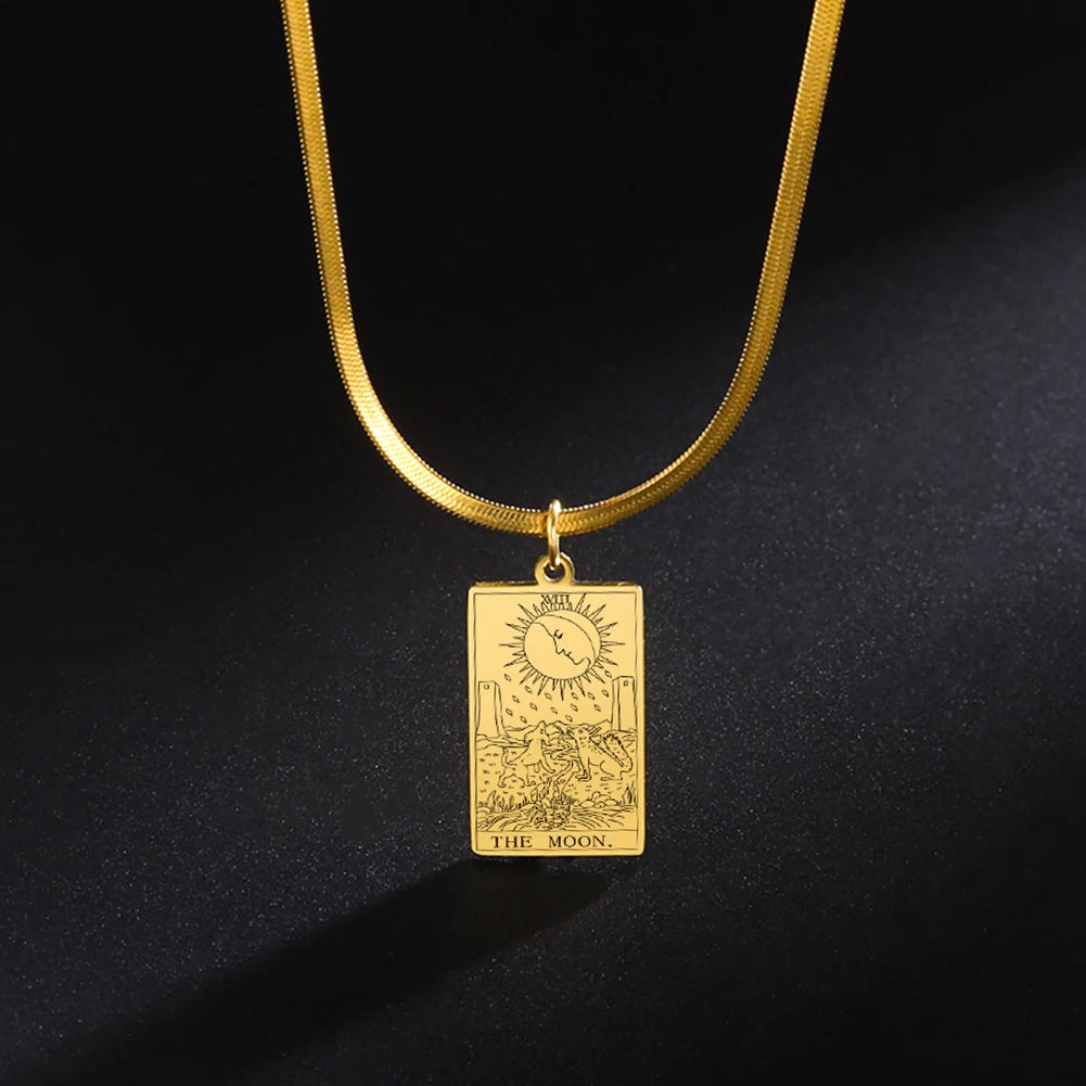 Gold pendant necklace with 'The Moon' tarot card design on a black background