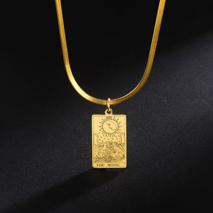 Gold pendant necklace with 'The Moon' tarot card design on a black background
