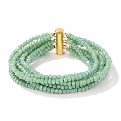 Green beaded bracelet with a gold clasp on a white background