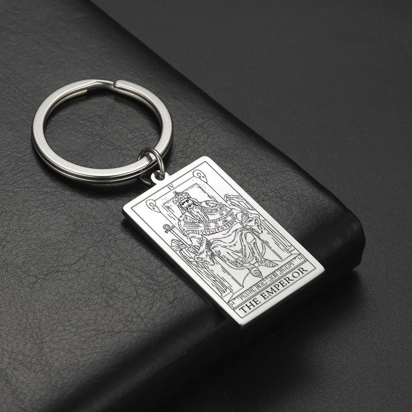 Keychain with tarot card design on a dark surface