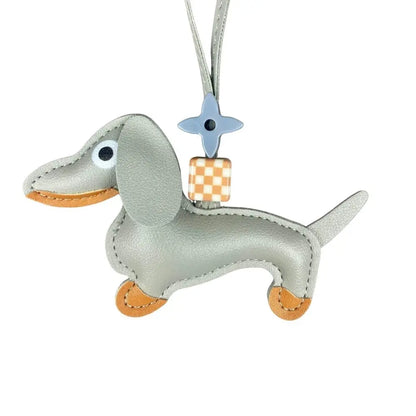 Grey dachshund-shaped keychain with a checkered bottom on a white background